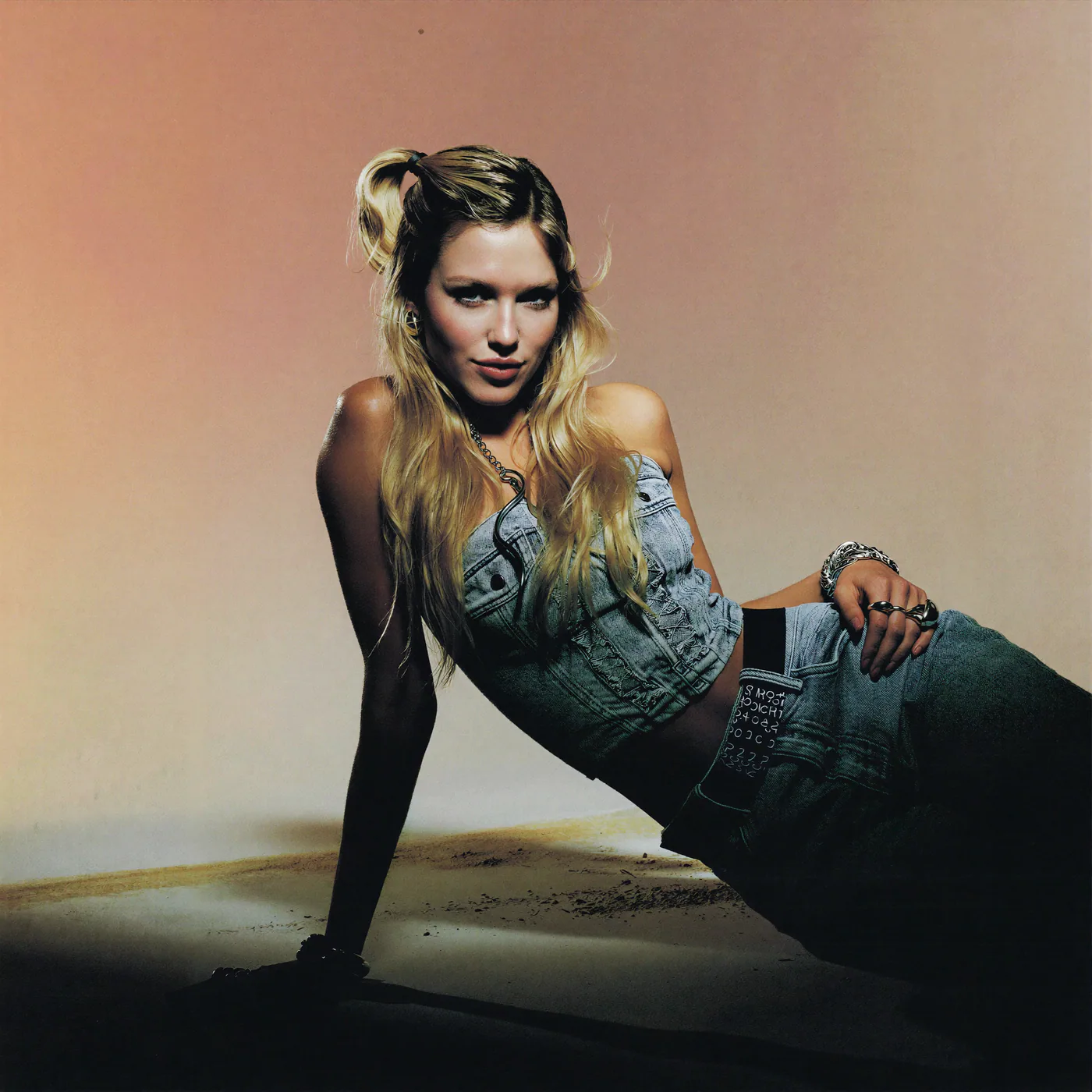 Cinematic fashion pose on a warm studio floor