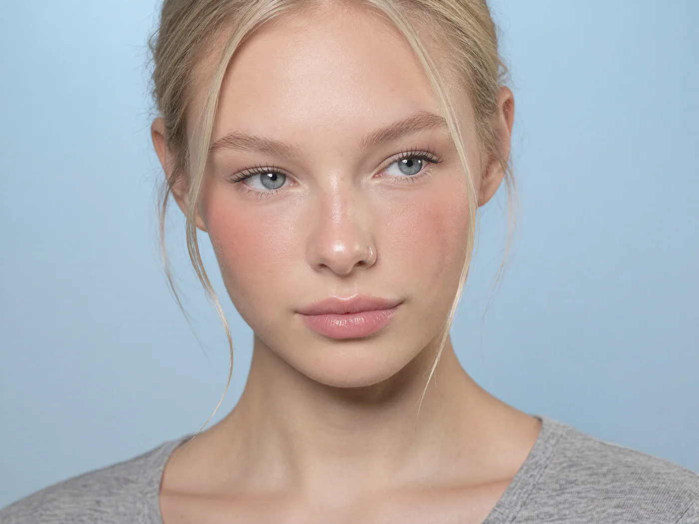 Clean model profile portrait against a pale blue background