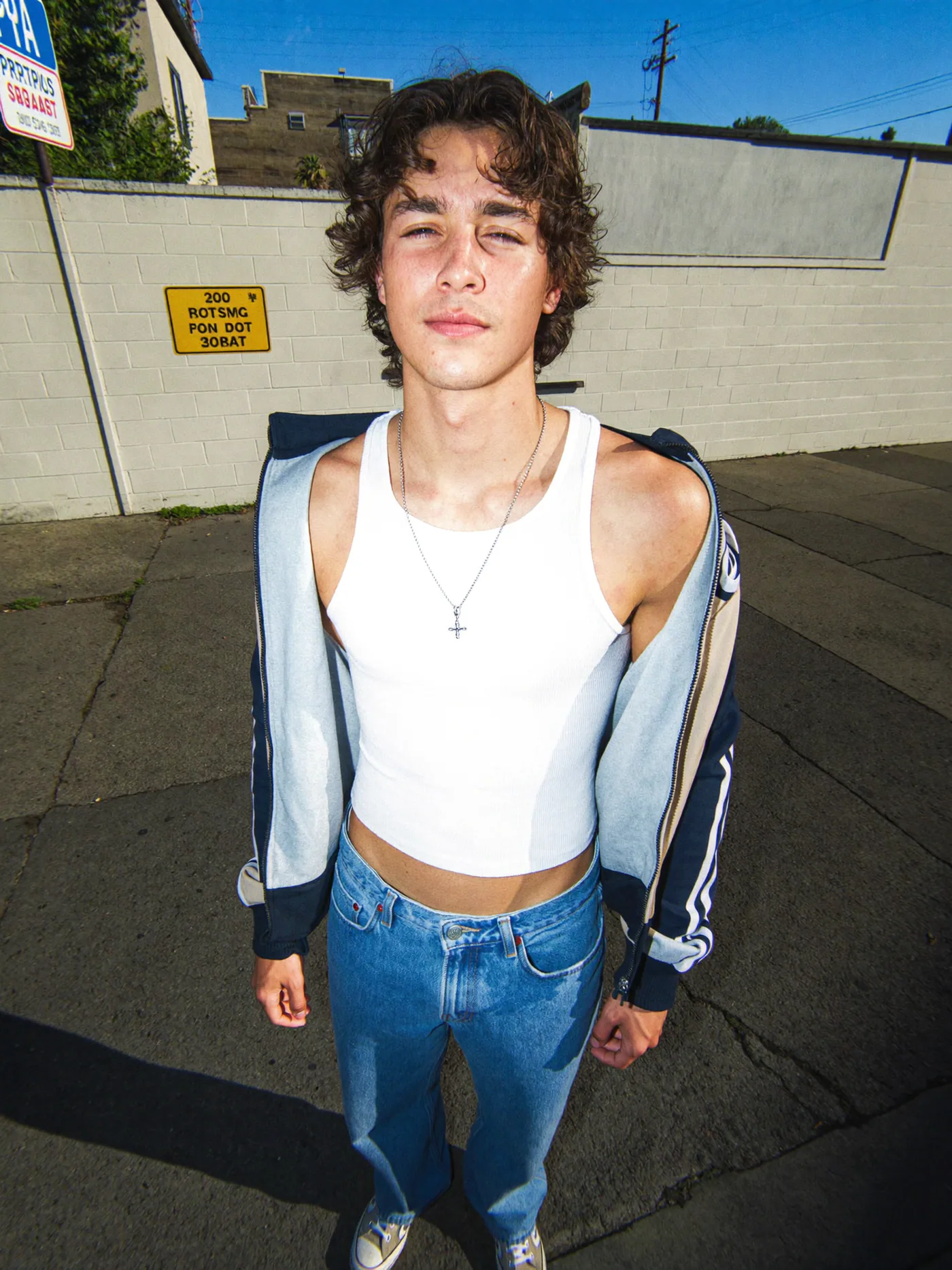 Fisheye sidewalk portrait in a white tank top