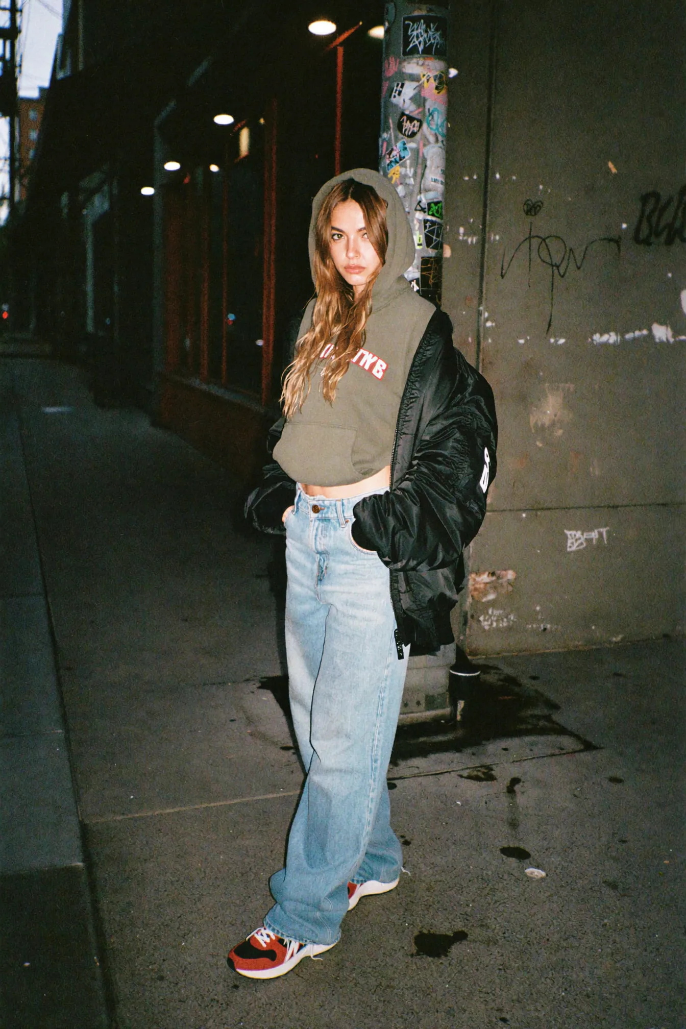 Night sidewalk fashion portrait with direct flash