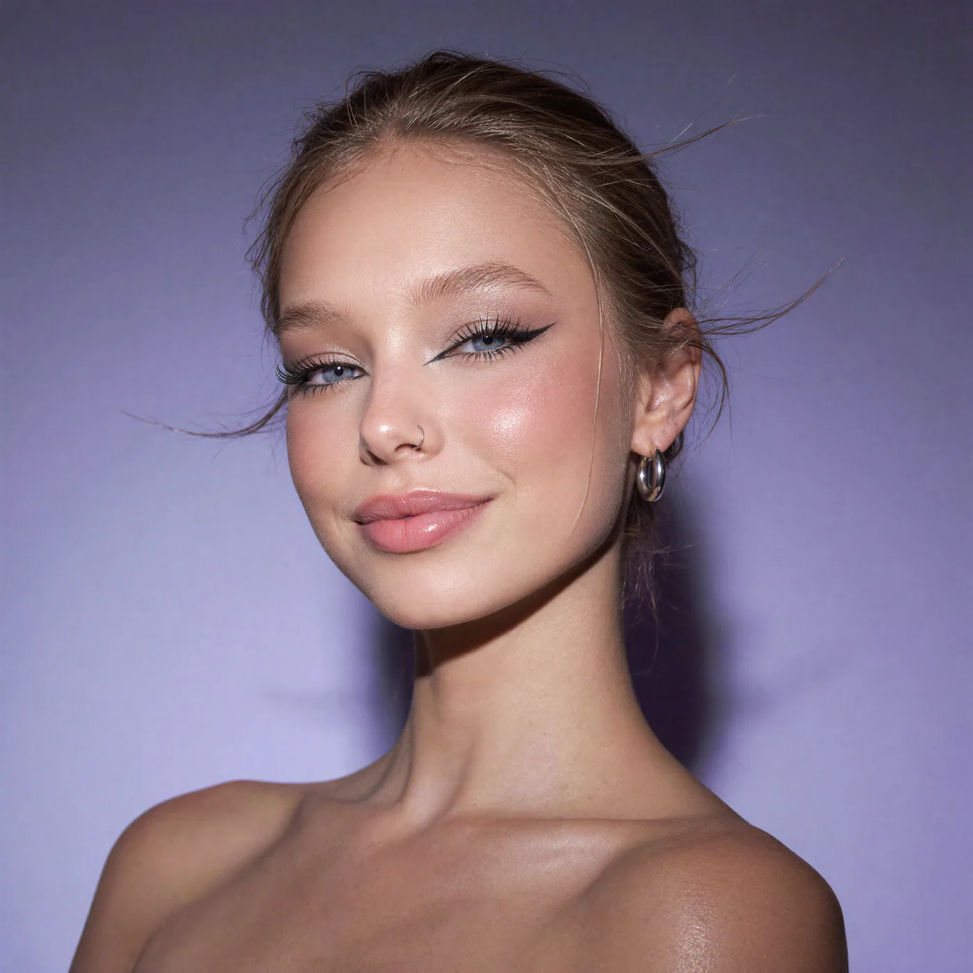 First polished blonde beauty portrait on violet