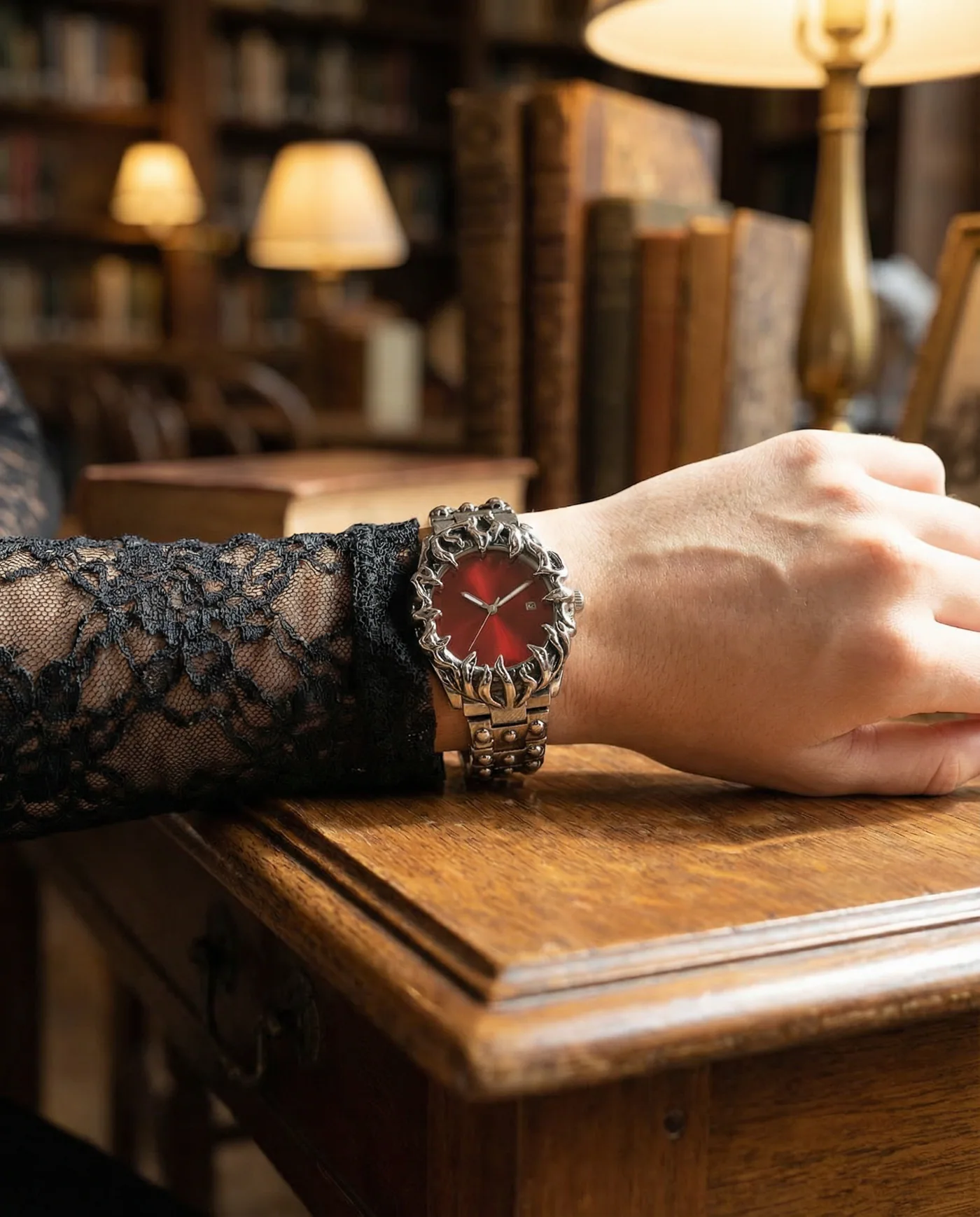 Close-up product detail of a red watch on a tattooed wrist