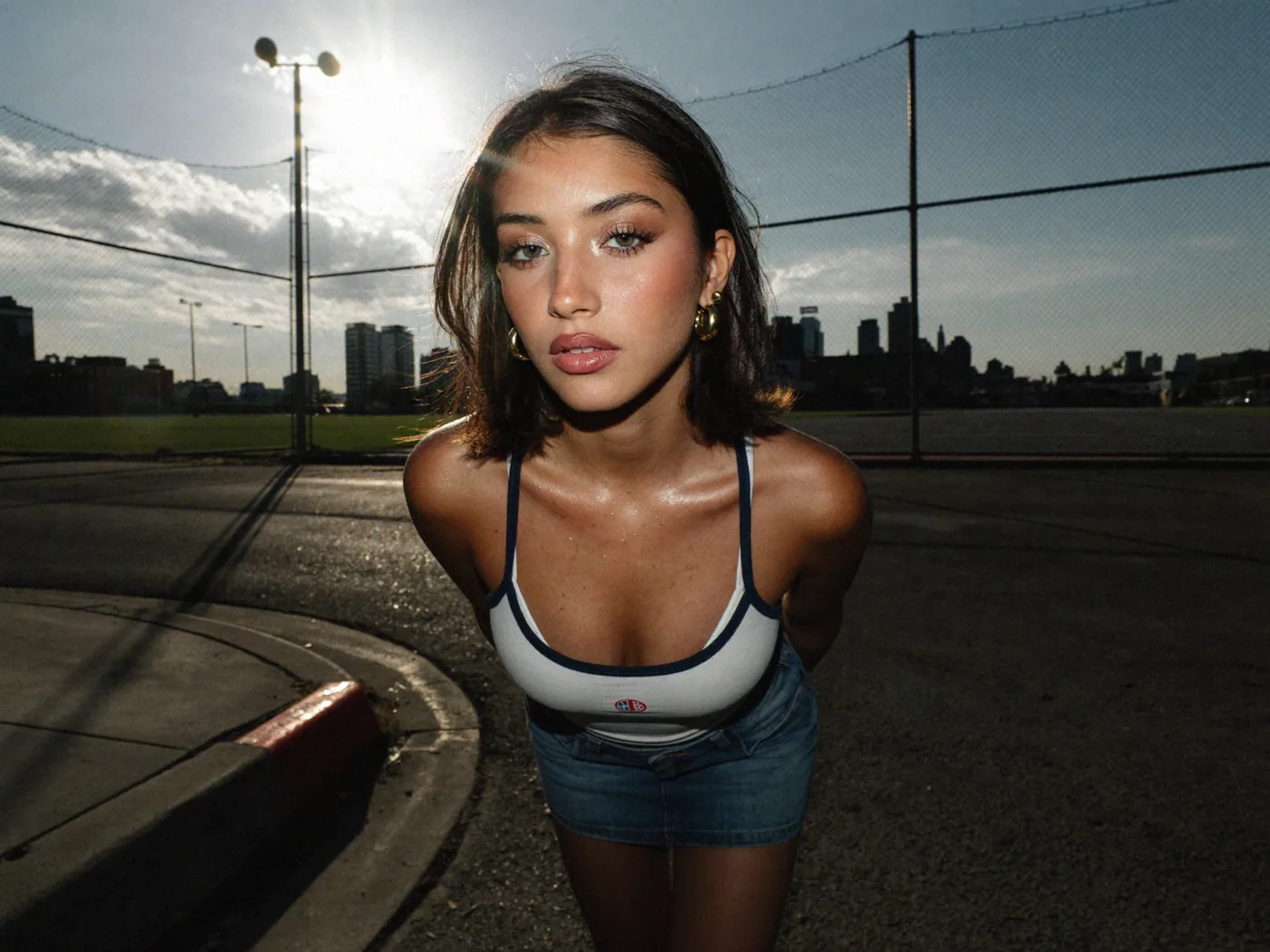 Wide-angle city portrait beside a reflective car